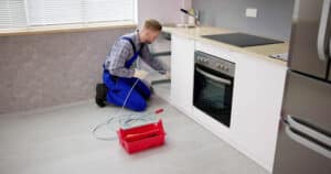 A plumber performing a drain cleaning service.