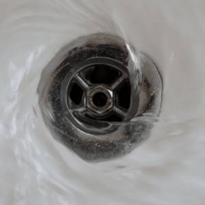 Water flowing into sink drain