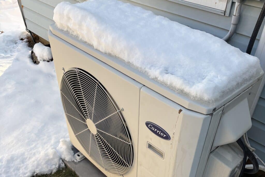 An outdoor HVAC unit is shown. Magnolia can help prevent winter HVAC plumbing and electrical emergencies