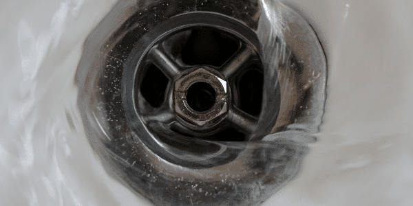 Water flowing into sink drain